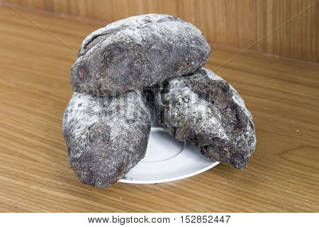 crispy bread on white dish on wood background