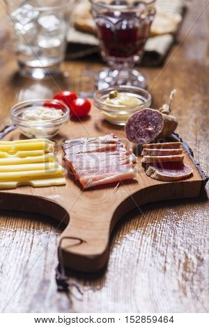 south tyrolean specialites on wood with wine