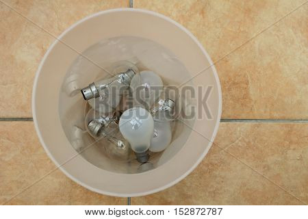 Old Incandescent Light Bulbs Discarded In A Trash Can - Green Eco Concept
