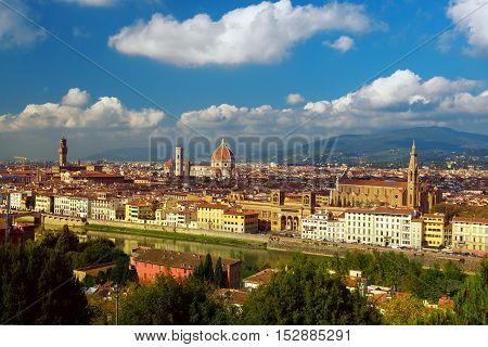 View of the beautiful medieval italian city and culture capital - Florence with cathedrals and bridges over river and blue cloudy sky. Travel outdoor sightseeing historical background.