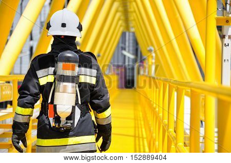 Firefighter in oil and gas industry with mission successful for protect with emergency case or worst case, Personal protective equipment of firefighter team and teamwork for danger mission.