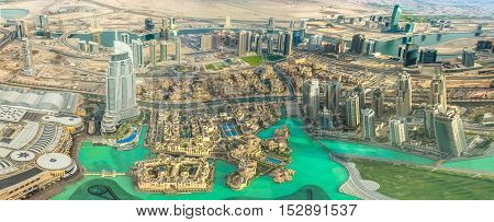 Aerial view of Dubai Mall, Dubai Fountain and Burj Khalifa Lake area in Dubai downtown, United Arab Emirates, from top.