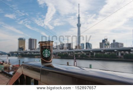TOKYO  , JAPAN - OCTOBER 13 ,2016 : cup coffee Starbucks in Tokyo , view Skytree and Sumida River background.