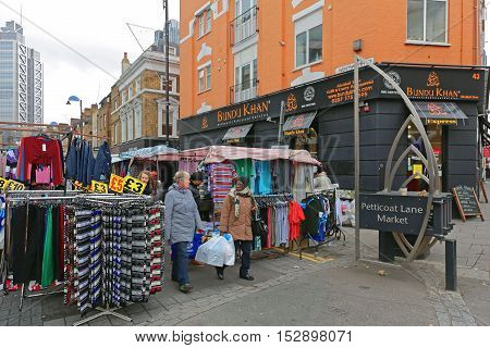 LONDON UNITED KINGDOM - NOVEMBER 24: Petticoat Lane Market in London on NOVEMBER 24 2013. Petticoat Lane Market With Clothing Stalls at Sunday in London United Kingdom.