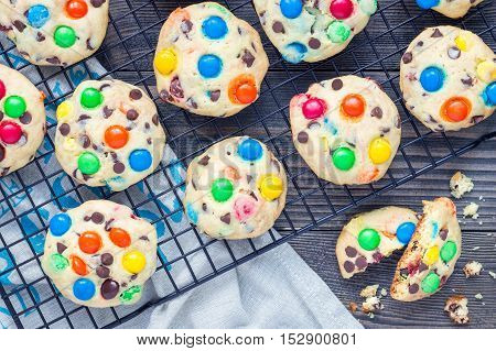 Shortbread cookies with multi-colored candy and chocolate chips on cooling rack horizontal top view