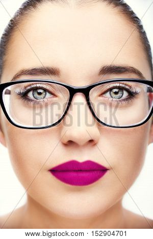 Attractive young optician woman with blue eyes In glasses