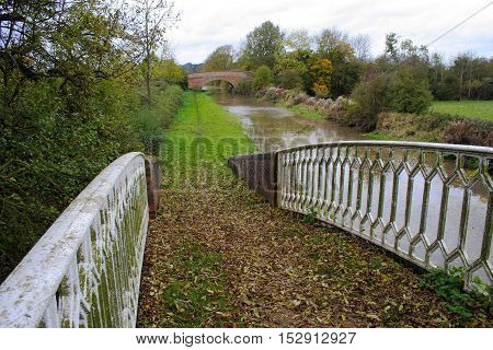 Rural canal tow path on an overcast Autumn day in Warwickshire United Kingdom