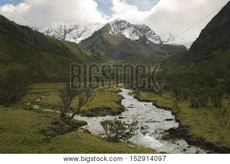 River of melted water of the Tullparahu glacier flowing down the valley of Quillcayhuance, Peru