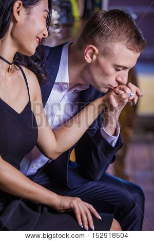Seductive man kissing his wifes hand before they go to the bedroom