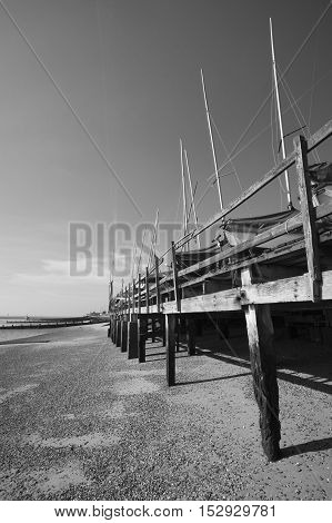 Black and white image of boats in winter storage on Southend Beach Essex England
