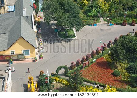 View over colourful village houses intersection and park
