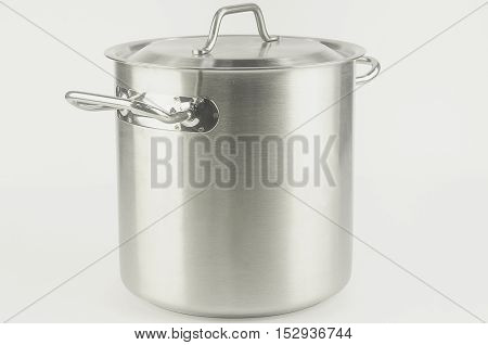 A large metal pot closed the lid standing on white background