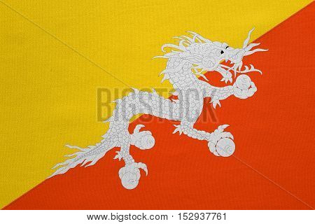 Bhutanese national official flag. Patriotic symbol banner element background. Correct colors. Flag of Bhutan with real detailed fabric texture accurate size illustration