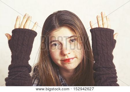 Teen pretty girl show hands in woolen fingerless mittens close up portrait. Girl teenager.