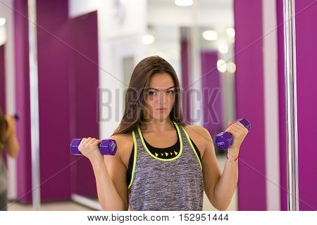 Pretty woman working out at the gym