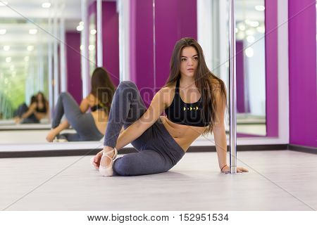 Pretty woman doing yoga in the studio