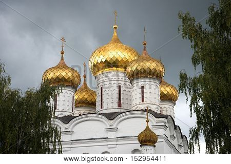 Domes of the old Cathedral of the Holy Trinity Ipatiev Monastery closeup gloomy September day. Kostroma Golden Ring of Russia
