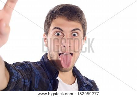 Portrait of a young handsome man taking a selfie. Isolated white background.