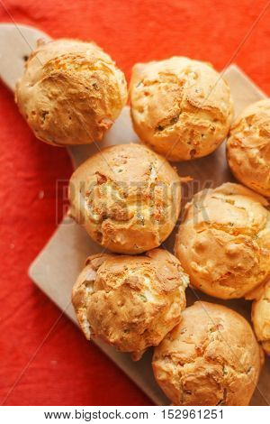 Tasty homemade salty cupcakes served on wooden plate selective focus