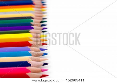 Colored pencils isolated on white background. Bright template with copyspace. Educational background.