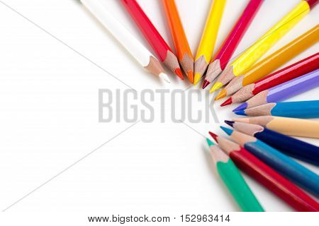 Colored pencils isolated on white background. Bright template with copyspace. Educational background.