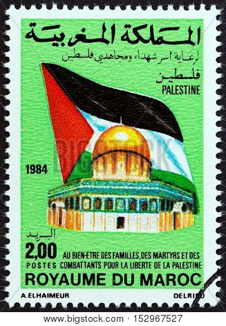 MOROCCO - CIRCA 1984: A stamp printed in Morocco shows Palestinian flag and Dome of the Rock, circa 1984.