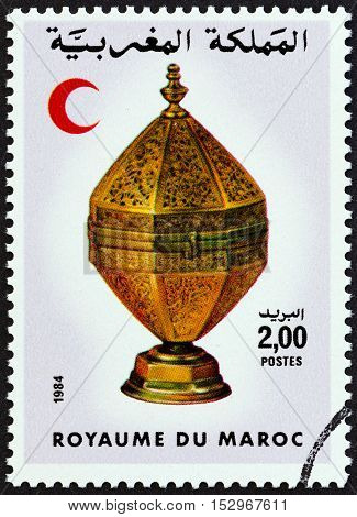 MOROCCO - CIRCA 1984: A stamp printed in Morocco shows Red Crescent and Octagonal brass container, circa 1984.