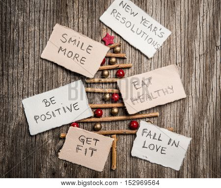 Christmas Tree And New Year Resolutions On Rustic Wooden Background