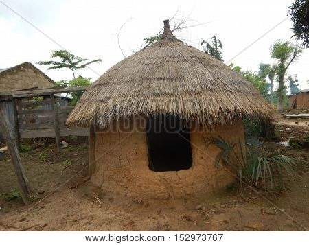 Native food silos for grain and food storage in Erena Niger State Nigeria. This one has a relatively full size door that allows people to enter. This one also has a foundation while the structure is made out of mud. The roof is made of thatch.