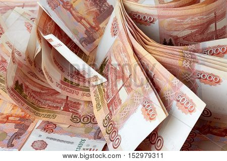 Bundle of rubles, a lot of money as background.