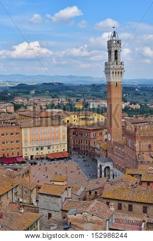 Siena, Italy - October 1, 2016: Tourists and spectators inside Piazza del Campo in a cloudy day, Siena, region of Tuscany, Italy