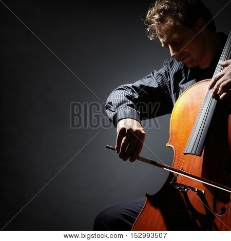 Cello player or cellist performing in an orchestra isolated with copy space