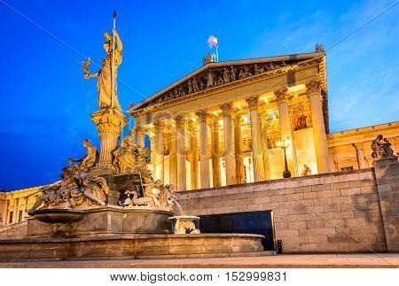 Vienna Austria. Austrian parliament building with Athena statue on the front in Wien on the twilight.