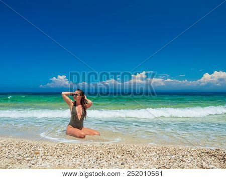 woman sunbathing on the beach summer travel holidays