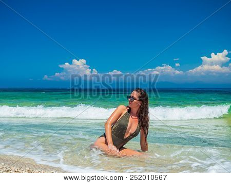 woman sunbathing on the beach summer travel holidays