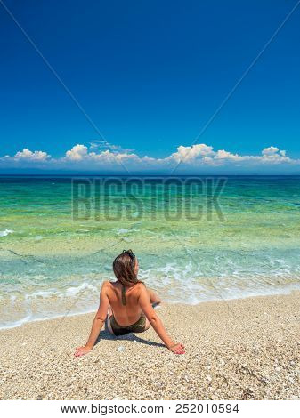 woman sunbathing on the beach summer travel holidays