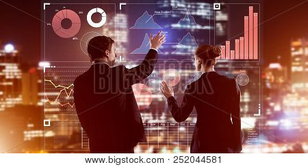 Two Business People Standing With Back And Working Together With Virtual Screen