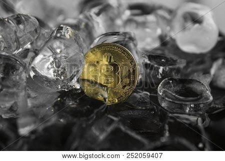 Gold Bitcoin On Ice Background. The Concept Of The Exchange In Winter. Freeze. Blockchain Mining. Di