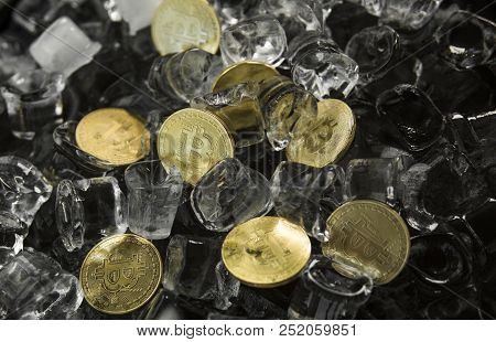 Many Gold Bitcoin Coins On Ice Background. Freeze. Blockchain Mining. Digital Money And Virtual Cryp