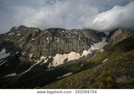 Mountain Landscape Of A Chaukhi Mountain Pass In Georgia. Heavy Clouds Over The Mountain Range.