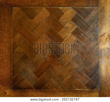 Old wooden maple table with fishbone pattern top view