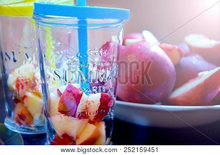 Preparation Of Fruit Water. Summer Drink From Peaches And Nectarine. Fruits On A Plate