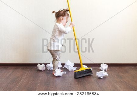 Child Sweeps Broom With Paper Bins In The Apartment, Household Chores