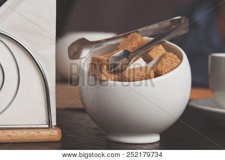 Sugar Bowl With Cubes Of White Cane Sugar, Sugar-tongs And Napkins. Atmosphere And Table Appointment