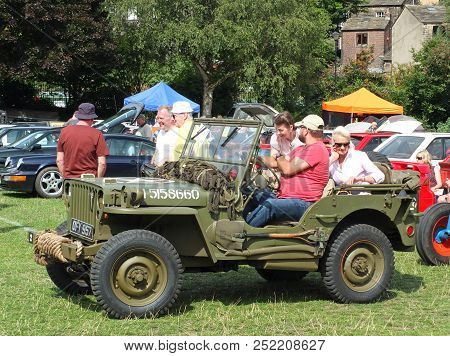 Hebden Bridge, West Yorkshire, England - August 4 2018: A Group Of People Sat In A Vintage Military 