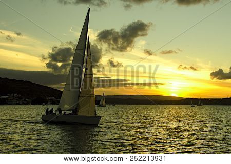 Australian Summer Seascape, Waterscape, Yellow Sunset With Primarily Stratocumulus Clouds Against A 