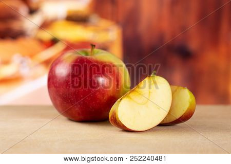 Group Of One Whole Two Slices Of Fresh Red Apple James Grieve Variety With Rustic Wood Kitchen In Ba