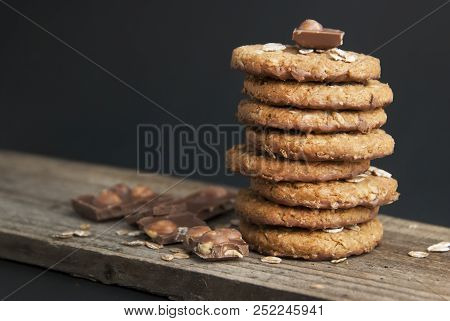 Oatmeal Cookies Or Biscuits With Oats, Nuts, Eggs And Flour On Brown Dark Woodenboard With Black Bac