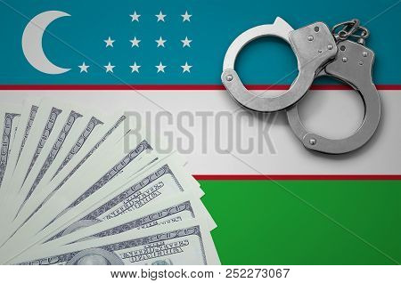 Uzbekistan Flag  With Handcuffs And A Bundle Of Dollars. The Concept Of Illegal Banking Operations I