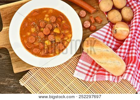 Potato Goulash With Debreziner Sausage Or German Name Is Kartoffelgulasch Mit Debreziner On Wooden B